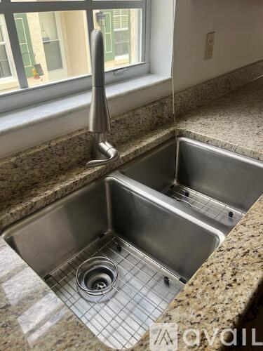 A kitchen sink with a faucet and a drain.