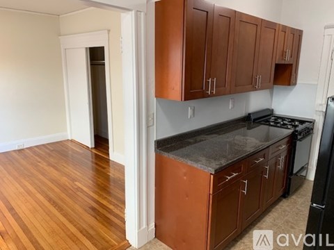 A kitchen with wooden cabinets and a black stove top.