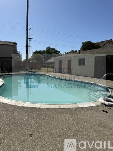 A pool with the words "Property Management" written on the fence.