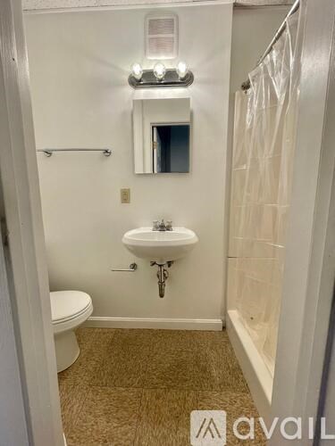 A bathroom with a sink, mirror, and toilet.