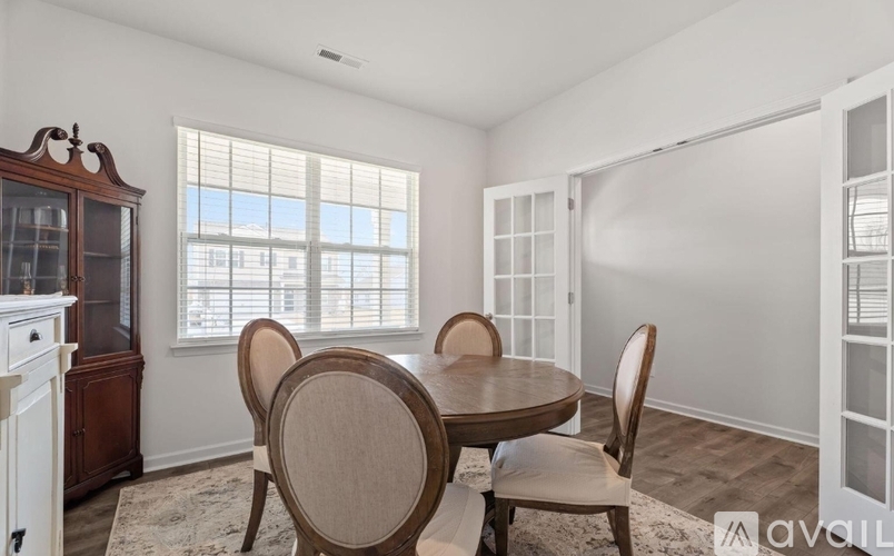 A dining room with a table and chairs.