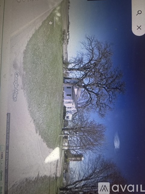 A street view of a building with a tree in front of it.