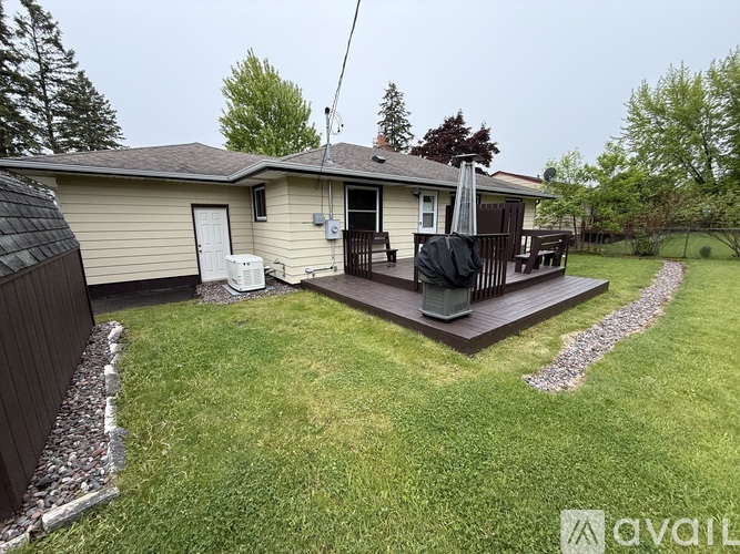 A house with a small deck and a patio umbrella.
