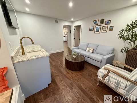 A living room with a grey couch and a wooden coffee table.