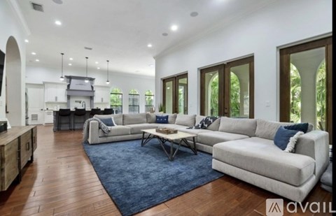 A spacious living room with a large sectional sofa and a coffee table.
