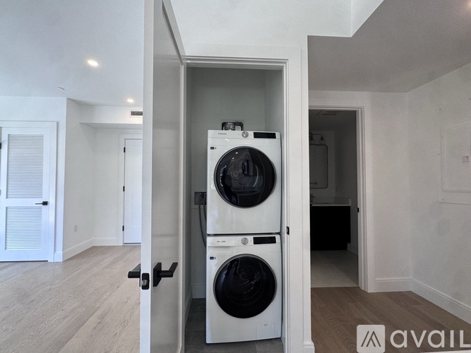 A washer and dryer are stacked on top of each other in a laundry room.