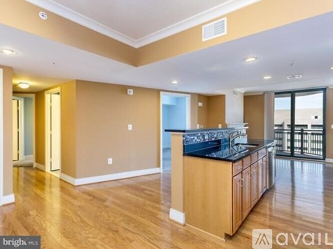 A spacious kitchen with wooden cabinets and a black countertop.