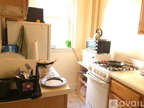 A small kitchen with a white stove and a white dishwasher.