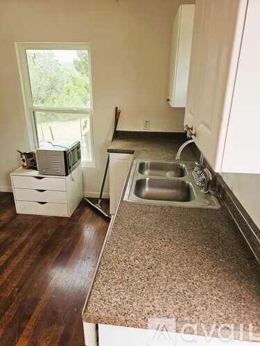 A kitchen with a sink and a window.