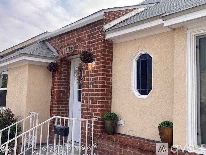 A house with a white door and a mailbox on the front porch.