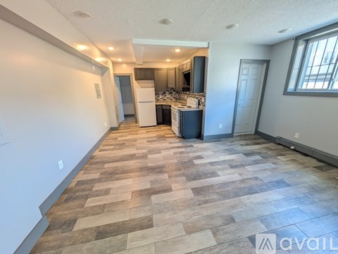 A spacious kitchen with a refrigerator, microwave, and oven.