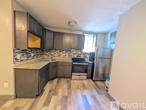 A kitchen with a refrigerator, oven, and microwave.