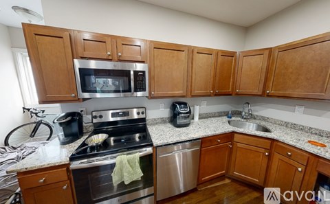 A kitchen with wooden cabinets and stainless steel appliances.