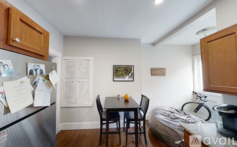 A kitchen with a table and chairs in the middle of the room.