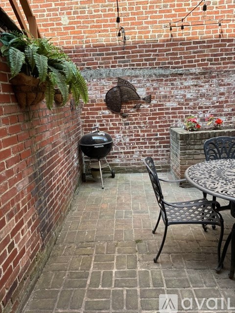 A small patio with a table and chairs.
