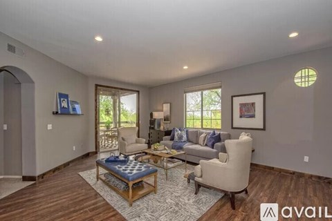 A living room with a couch, chair, and coffee table.