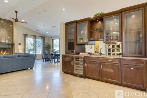 A modern kitchen with wooden cabinets and a dining table.