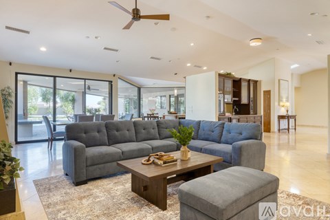 A living room with a grey couch and a coffee table.