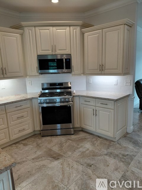 A kitchen with a stove top oven and microwave.