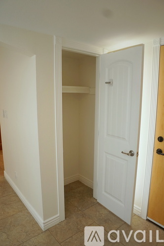 A white door is in a room with a tan wall.