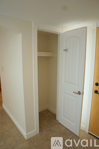 A white door is in a room with a tan wall.