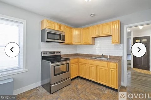 A kitchen with wooden cabinets and a stainless steel oven.