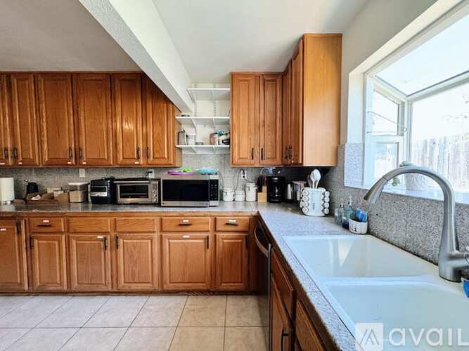 A kitchen with wooden cabinets and a white countertop.