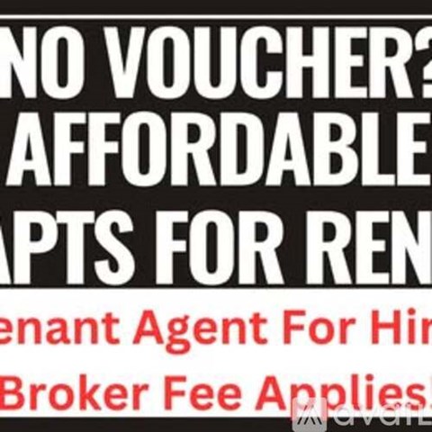 A sign advertising a broker fee applies for rent.