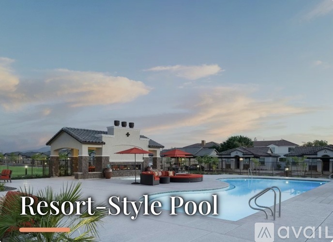 A resort-style pool area with a building and lounging areas.