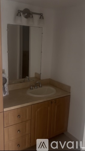 A bathroom with a sink and mirror.