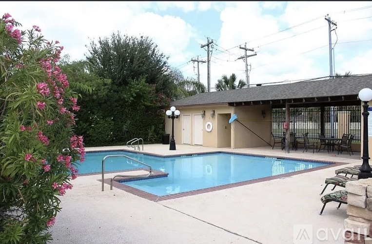 A pool with a building behind it.