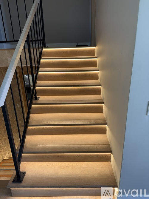 A staircase with wooden steps and a metal railing.