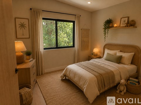 A bedroom with a large bed and a window with curtains.