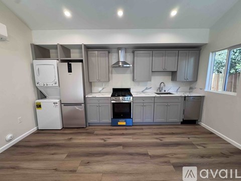 A kitchen with a white refrigerator, a white oven, and a white microwave.