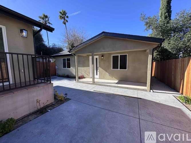 A house with a driveway and a fence.