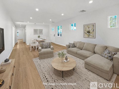 A living room with a white couch and a coffee table.