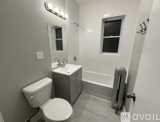 A white toilet is next to a sink in a small bathroom.