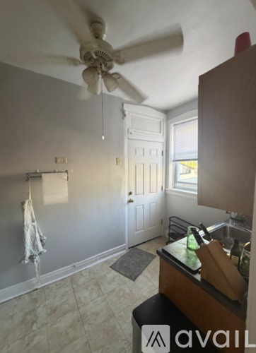 A kitchen with a fan and a door.