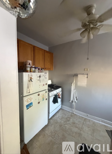 A kitchen with a fridge and a fan.