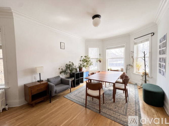 A living room with a wooden floor and furniture.