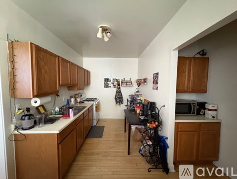 A kitchen with wooden cabinets and a white countertop.