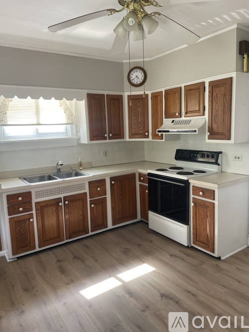A kitchen with wooden cabinets and a white countertop.
