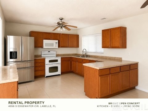 A kitchen with wooden cabinets and a marble countertop.