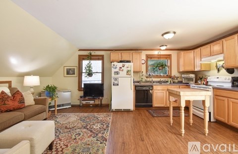 A kitchen with wooden cabinets and a white refrigerator.