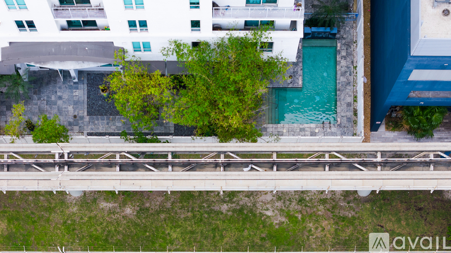 A modern building with a pool and a bridge.