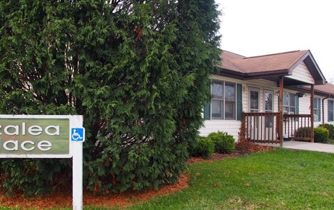A sign for a place called "Salea Place" is in front of a house.