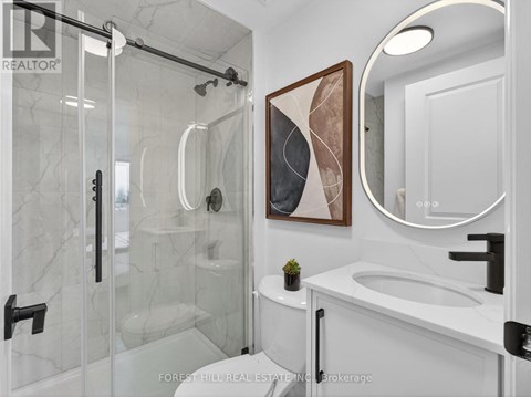 A bathroom with a marble toilet and a large mirror.