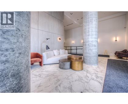 A living room with a white couch and a marble floor.