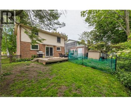 A house with a backyard and a fence.