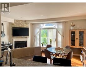 A living room with a fireplace and a dining table.